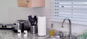 a kitchen counter with a sink with a roll of paper towels at Loft Close to Downtown, Raymond James Stadium, Airport and Many More Places in Tampa