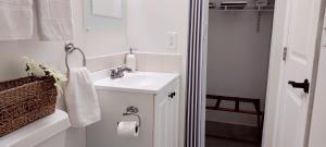 a white bathroom with a sink and a shower at Loft Close to Downtown, Raymond James Stadium, Airport and Many More Places in Tampa +28 photos