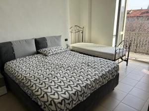 a bedroom with two beds and a balcony at Typical one bedroom apartment in Turin center in Turin