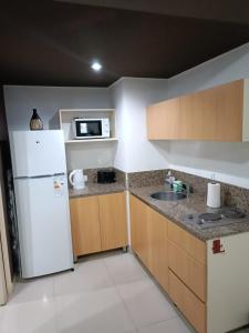 a kitchen with a white refrigerator and a sink at Monoambiente en Montserrat "departamentosji" in Buenos Aires