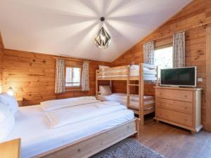 a bedroom with two bunk beds and a flat screen tv at Waldberg in Krimml
