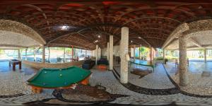 a billiard room with a pool table in a building at Chale 48 Maragogi Village Gales in Maragogi