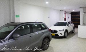 two cars are parked in a garage at Hotel Santa Clara Graze in Pasto