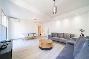 a living room with a couch and a table at Brand new 2 bedroom in the heart of Cannes in Cannes