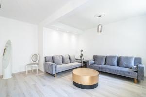 a living room with two blue couches and a table at Brand new 2 bedroom in the heart of Cannes in Cannes