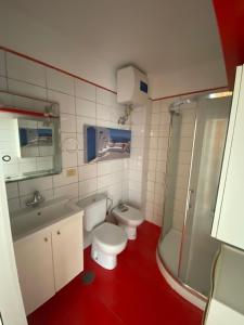 a bathroom with a toilet and a sink and a shower at Oasis del sur, sea view los cristianos in Los Cristianos