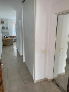 a hallway with white walls and a tile floor at Oasis del sur, sea view los cristianos in Los Cristianos