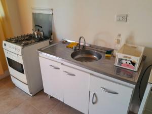 a kitchen with a sink and a stove at AYRES DE MONTAÑA in San Ignacio +18 photos