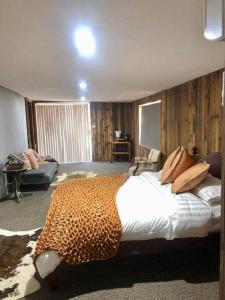 a bedroom with a leopard print bed in a room at Gorgeous Country Woolshed in Loomberah