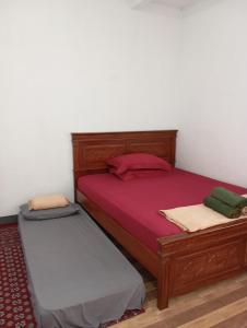 A bed or beds in a room at Hazza syaria homestay