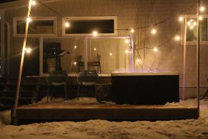 a house with chairs and lights in the snow at Oyster Shell Cottage in York