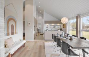 a dining room and kitchen with a table and chairs at 4 Bedroom Cozy Home In Hadsund in Hadsund
