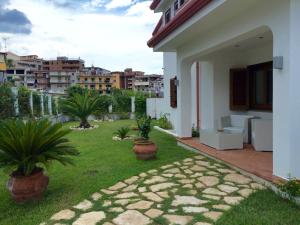 a house with a yard with plants in it at Villa il Barone in Tropea