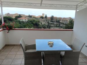 a table and chairs in a balcony with a view at Villa il Barone - Free Private Parking in Tropea