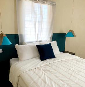 a bedroom with a bed with two blue lights at Hostal Casa Antigua Santa Ana in Santa Ana
