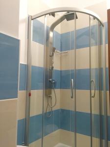 a shower with blue and white stripes in a bathroom at Villa il Barone in Tropea