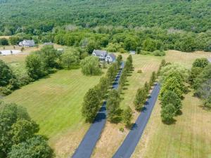 an aerial view of a house and a road in a field at Malkita Aria Mountainview Retreat in Woodbury +129 photos