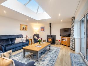 a living room with a couch and a table at Walcot House Stables in Diss