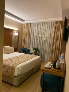 a hotel room with a bed and a table with a table at İstport Hotels in Arnavutköy