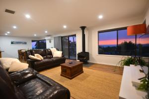 a living room with a couch and a stove at Jacks Kangaroo Island in Kingscote