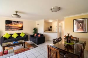 a living room with a couch and a table at Key Largo Holiday Apartments in Gold Coast