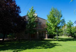 a house with trees in the front yard at Catar Sensaciones in Chacras de Coria