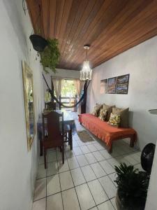 a bedroom with a bed and a table in a room at Nova Conquista in Paraty
