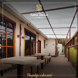 a row of tables and benches on a patio at Sama Jauka in Guano