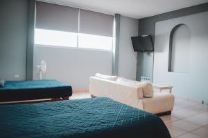 Rúm í herbergi á La Conspiración Hotel