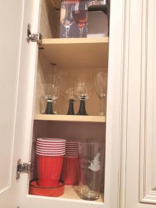 a cupboard with wine glasses and plates in it at Beautiful New 4 Bedroom 3 Bath Family Home Nr Howard U Downtown NW DC in Washington