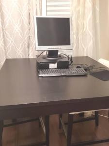 a desk with a computer monitor and a keyboard at Beautiful New 4 Bedroom 3 Bath Family Home Nr Howard U Downtown NW DC in Washington