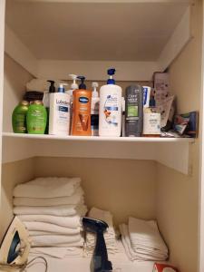 a cabinet filled with lots of toiletries and towels at Beautiful New 4 Bedroom 3 Bath Family Home Nr Howard U Downtown NW DC in Washington