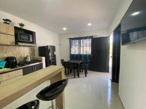 a kitchen with a table and a dining room at Apartamento central in Apartadó