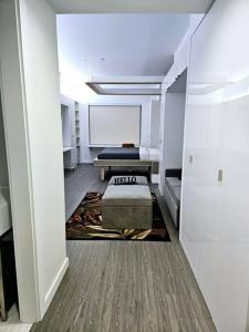 a room with a bed and a white wall at Tremont Smart 15 - A KCM Property in Cleveland