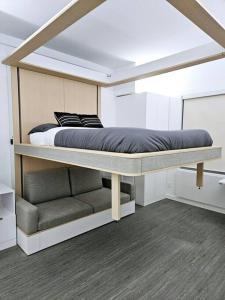 a bedroom with a bunk bed and a couch at Tremont Smart 15 - A KCM Property in Cleveland