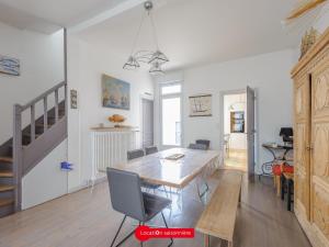 eine Küche und ein Esszimmer mit einem Tisch und Stühlen in der Unterkunft Maison Châtelaillon-Plage, 5 pièces, 8 personnes - FR-1-535-19 in Châtelaillon-Plage