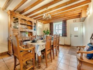 a dining room with a table and chairs at The Old Post Office in Fir Tree