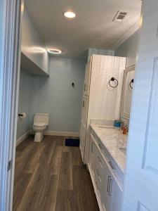 a bathroom with a sink and a toilet in it at Large 5 Bedroom Home Near Downtown Dalton in Dalton