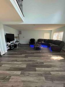 a living room with couches and a flat screen tv at Large 5 Bedroom Home Near Downtown Dalton in Dalton