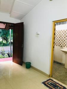 a room with a door open to a room with a room at Randiya Holiday Resort in Minneriya