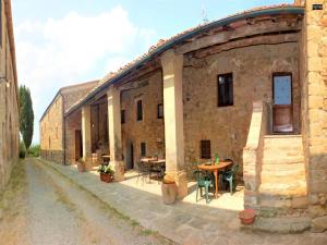 an old stone building with a table and chairs at Belvilla by OYO Allodola in Volterra