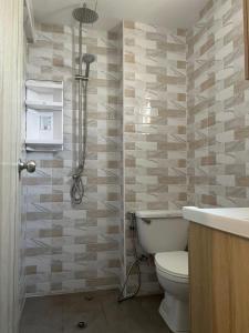 a bathroom with a toilet and a sink at Patong Vacation Rentals - Studio Apartments - Located in the Heart of Patong with Kitchen, Private Bathroom, Seating Area, 65" Smart TV with Free WIFI in Patong Beach