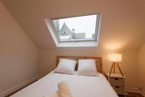 a bedroom with a bed with a window at Lafra - Charming & Intimate - Mon Groom in Troyes
