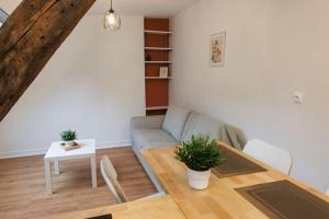 a living room with a couch and a table at Lafra - Charming & Intimate - Mon Groom in Troyes
