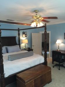 a bedroom with a bed with a ceiling fan at Huffman House Bed & Breakfast in Minden