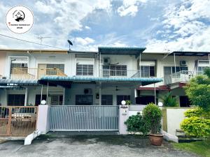 a large white house with a blue roof at i Homes 2 at Ipoh Town for Big Group in Ipoh