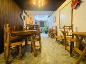 a dining room with wooden tables and chairs at Hotel 17-52 in Guatemala
