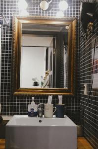 a bathroom with a sink with a mirror and a mirror at Hills&MING B&B in Shanghai