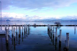 a large body of water with poles in the water at 国家公務員共済組合連合会びわこ保養所（KKRホテルびわこ） in Otsu