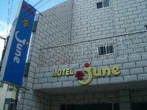 a building with a sign on the side of it at Jun Motel in Jeju